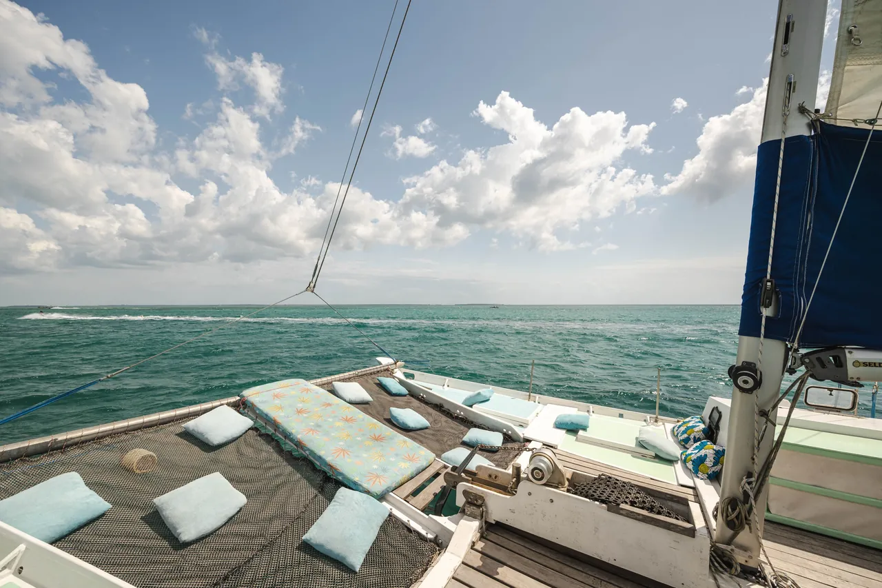 Cushions on the open front deck and trampolines of a catamaran at sea