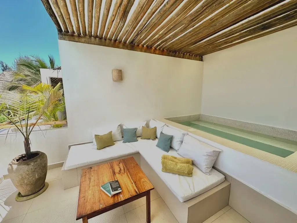 A terrace with a private plunge pool and day bed