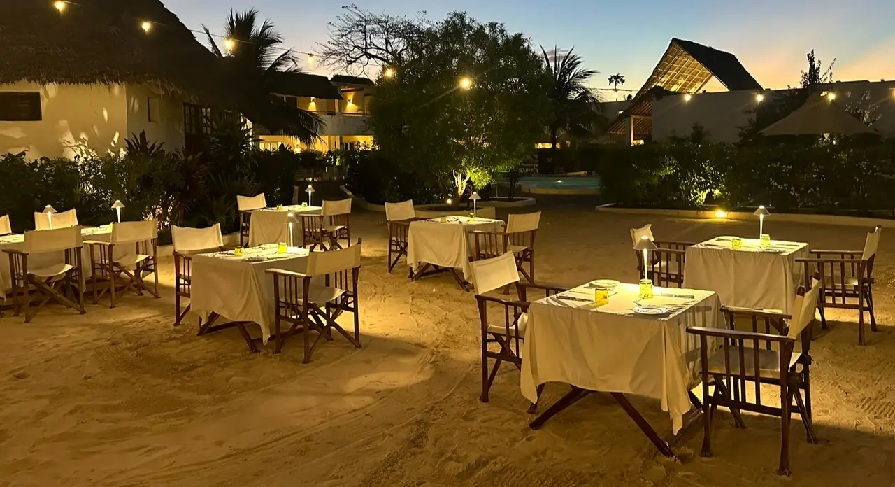 Candlelit tables in the garden restaurant at dusk
