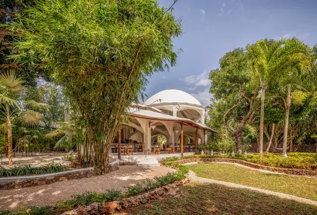 A white-domed pavilion set among bamboo and tropical gardens