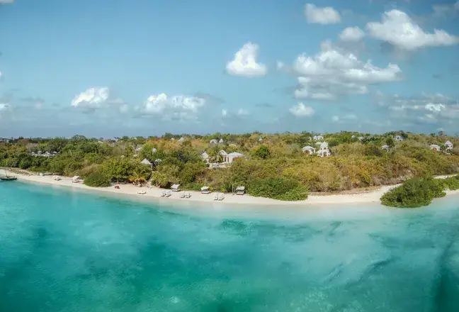 Aerial view of the estate's gardens running down to the beach and turquoise water