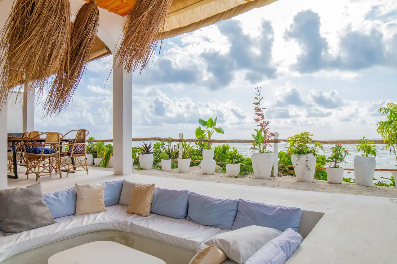 A sunken lounge with cushions on a terrace overlooking the sea