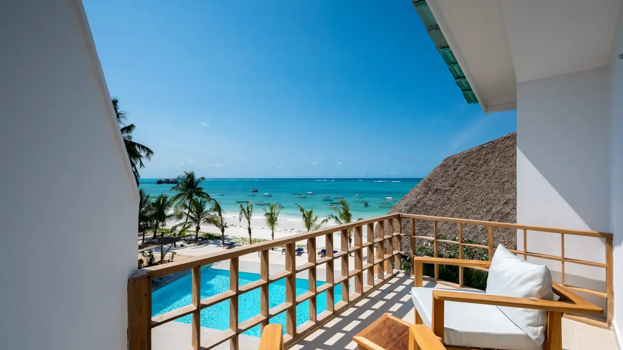 A balcony looking over the pool to the beach