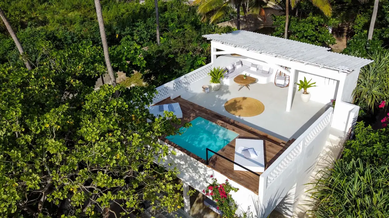 Aerial view of a white villa roof with a private plunge pool