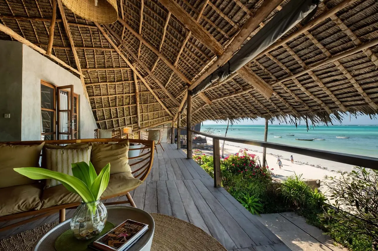 A thatched wooden deck running along the beachfront