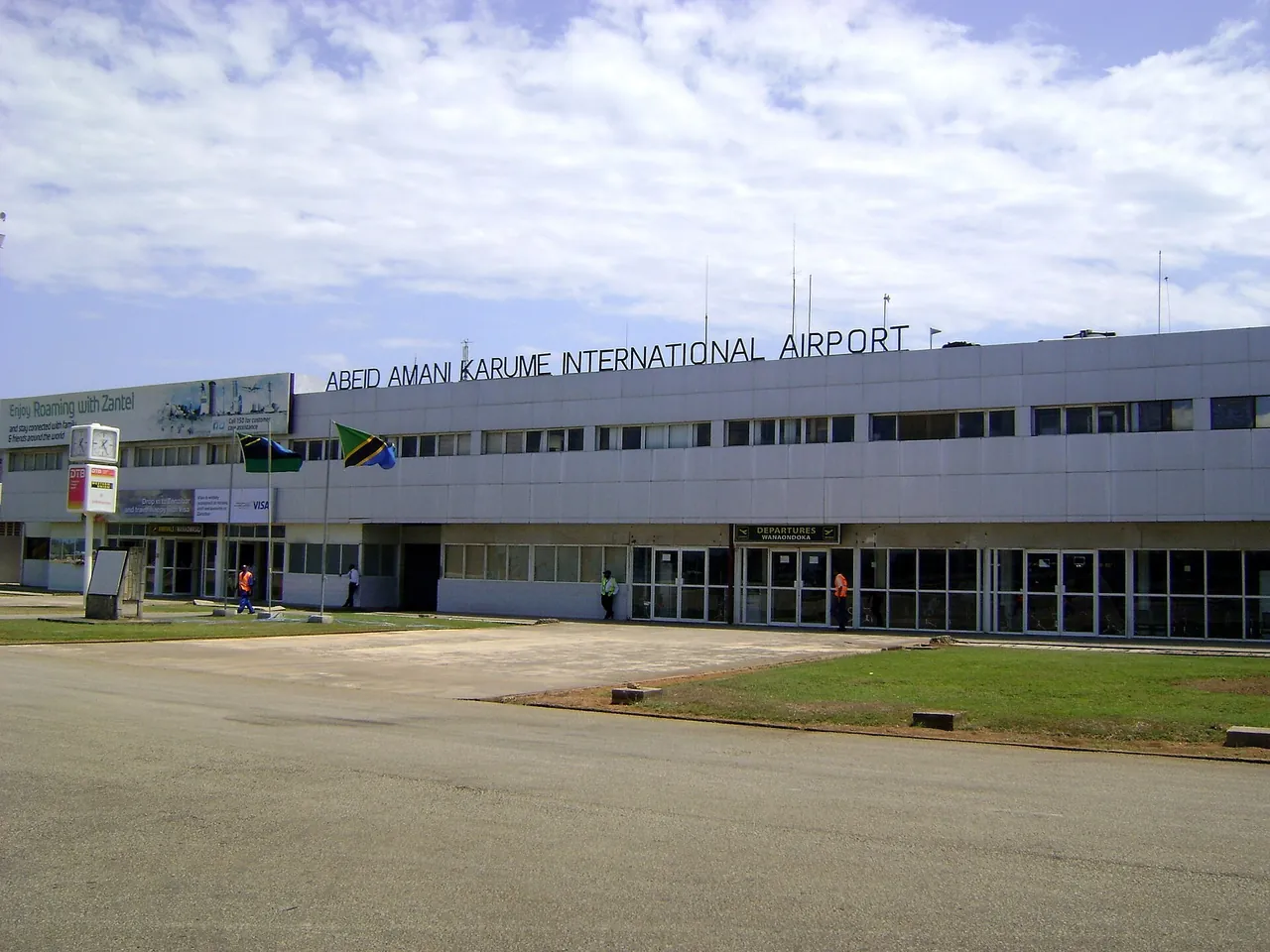 Low grey terminal building with "Abeid Amani Karume International Airport" lettering