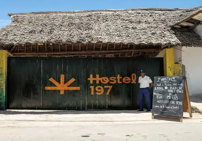 Entrance of Hostel 197 in Nungwi with a chalkboard sign