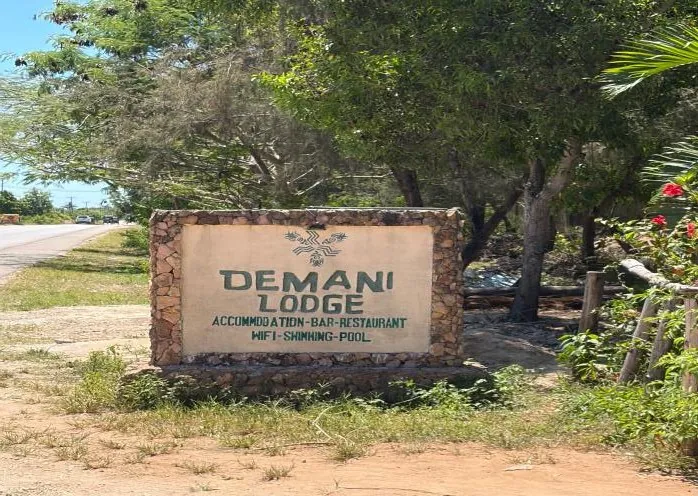 Stone roadside sign for Demani Lodge