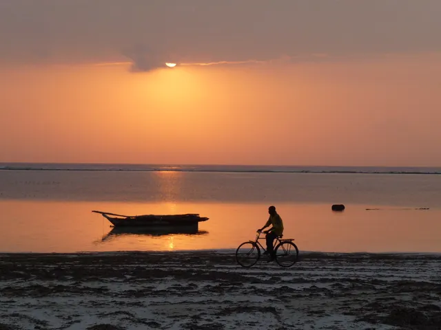 Sunrise over the sea at Matemwe with an outrigger boat