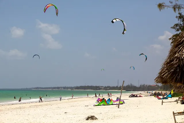 Kitesurf kites over the turquoise lagoon at Paje