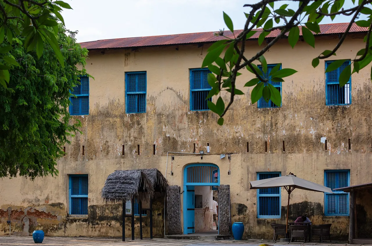 The two-storey colonial prison building on Changuu, its yellow walls weathered, with blue shutters