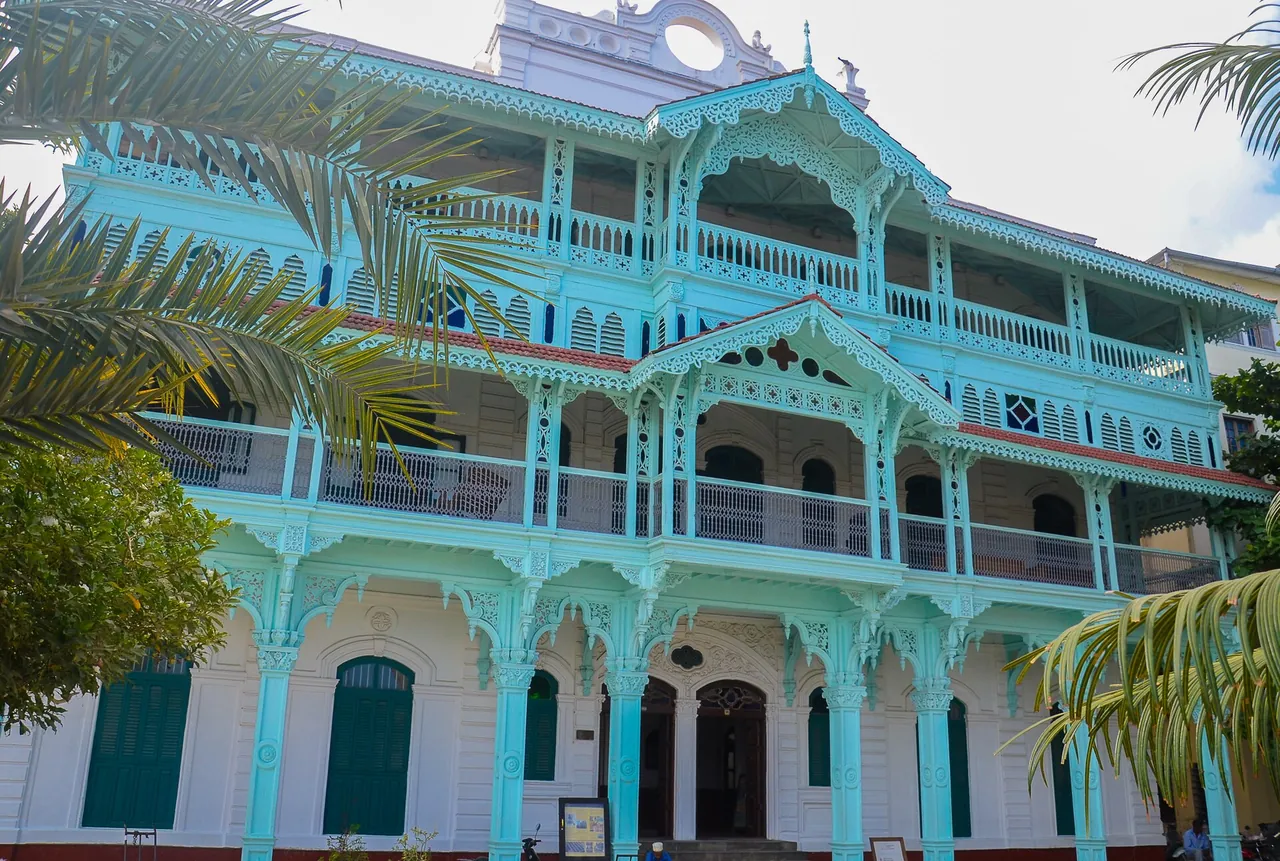The Old Dispensary on the Stone Town seafront, with tiered carved wooden balconies painted pale green