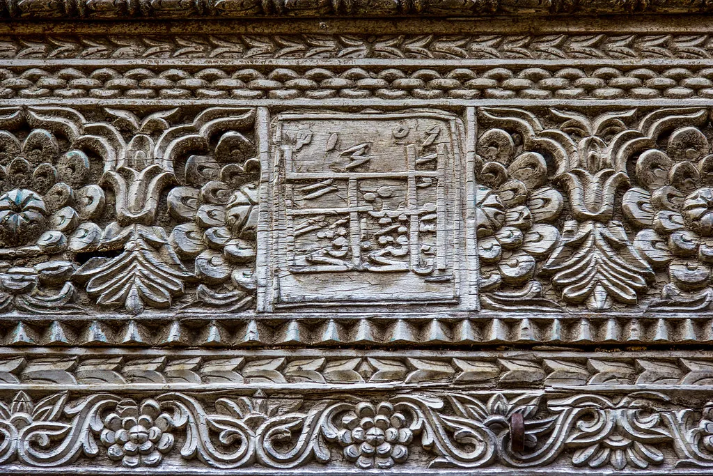 Close-up of dense floral wood carving on the lintel of a Zanzibar door