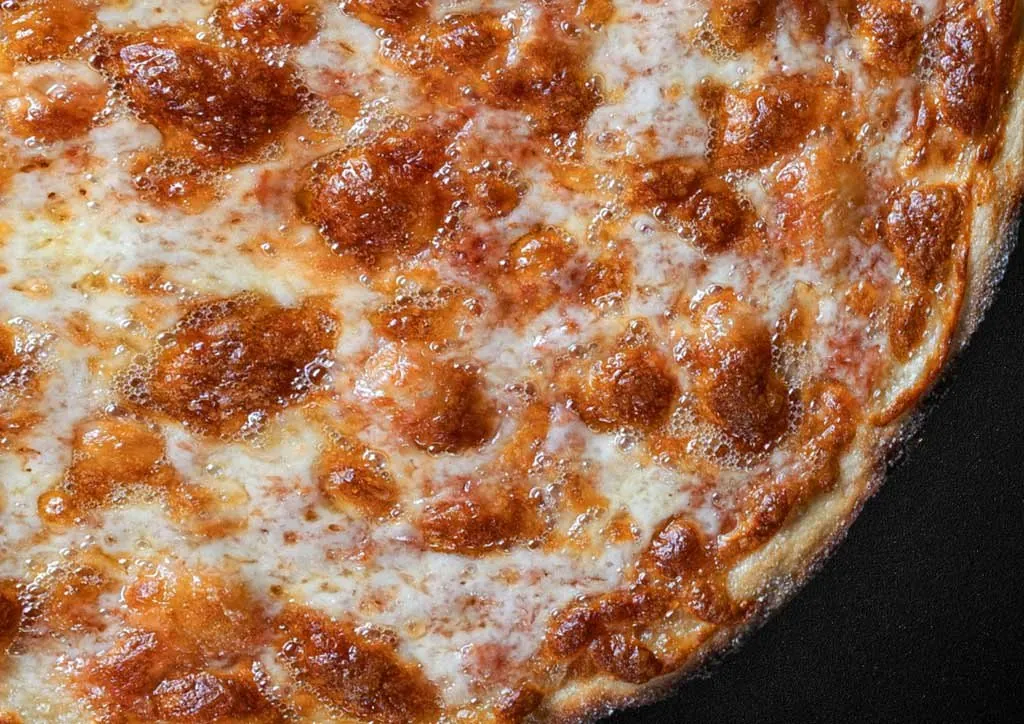 Close-up of a Margherita pizza with a blistered, crunchy base